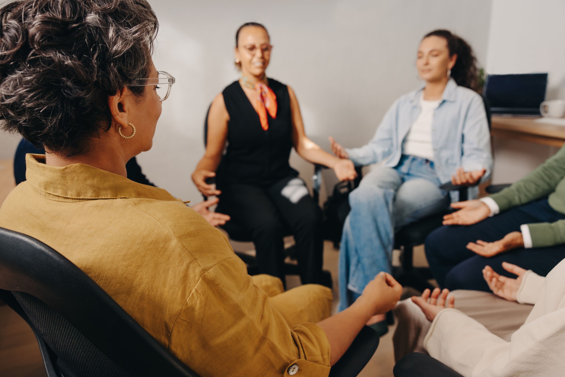 Colleagues practicing mindfulness meditation together in the workplace for relaxation